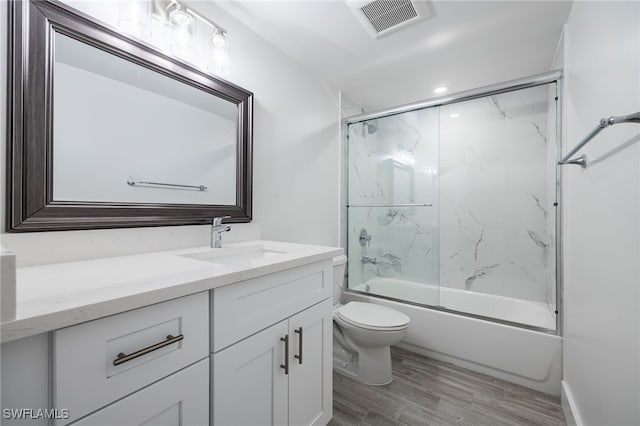1830 Brantley Rd Unit A2, Fort Myers, FL 33907 - bathroom featuring vanity, toilet, wood finished floors, and bath / shower combo with glass door