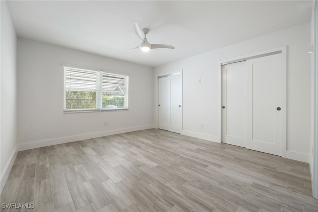 1830 Brantley Rd Unit A2, Fort Myers, FL 33907 - unfurnished bedroom with multiple closets, light wood-style flooring, baseboards, and ceiling fan