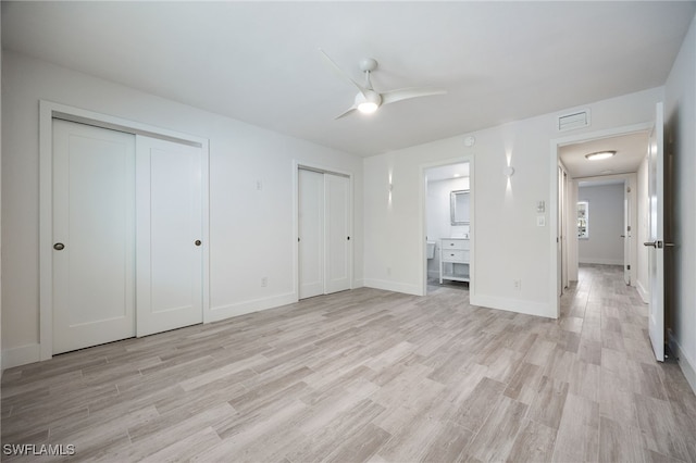 1830 Brantley Rd Unit A2, Fort Myers, FL 33907 - unfurnished bedroom featuring two closets, light wood finished floors, ensuite bathroom, and baseboards