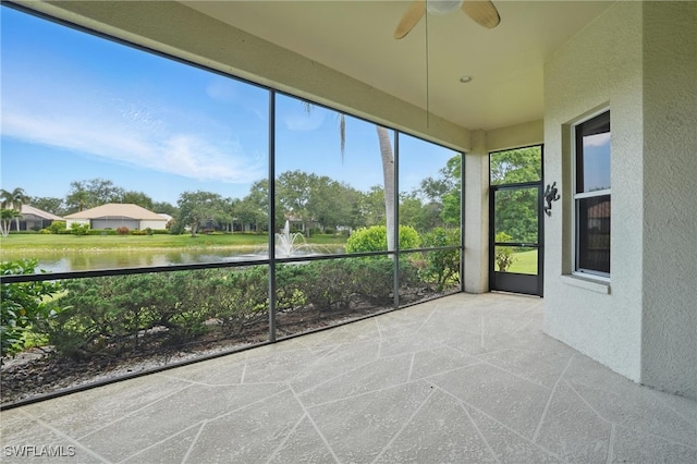 878 Vistana Cir Unit 50, Naples, FL 34119 - unfurnished sunroom with a textured wall, a water view, and ceiling fan