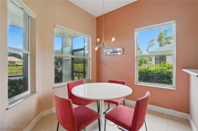 878 Vistana Cir Unit 50, Naples, FL 34119 - dining room with a chandelier, baseboards, and light tile patterned floors
