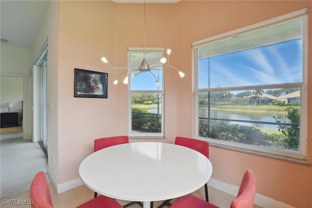 878 Vistana Cir Unit 50, Naples, FL 34119 - dining room featuring a chandelier, baseboards, and a water view