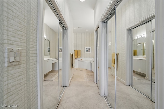 878 Vistana Cir Unit 50, Naples, FL 34119 - corridor with light colored carpet and wallpapered walls