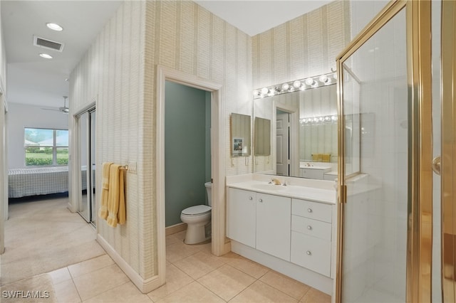 878 Vistana Cir Unit 50, Naples, FL 34119 - ensuite bathroom featuring wallpapered walls, toilet, vanity, a shower stall, and tile patterned flooring