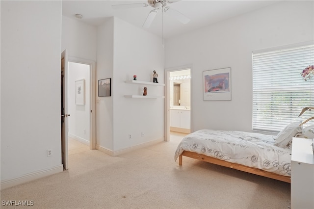 878 Vistana Cir Unit 50, Naples, FL 34119 - bedroom featuring light carpet, baseboards, connected bathroom, and a ceiling fan