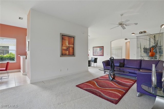 878 Vistana Cir Unit 50, Naples, FL 34119 - living room featuring arched walkways, carpet, ceiling fan, and baseboards