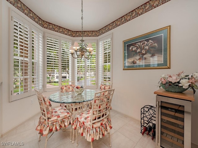 8440 Abbington Cir Unit D16, Naples, FL 34108 - dining area featuring beverage cooler, a chandelier, tile patterned floors, and baseboards