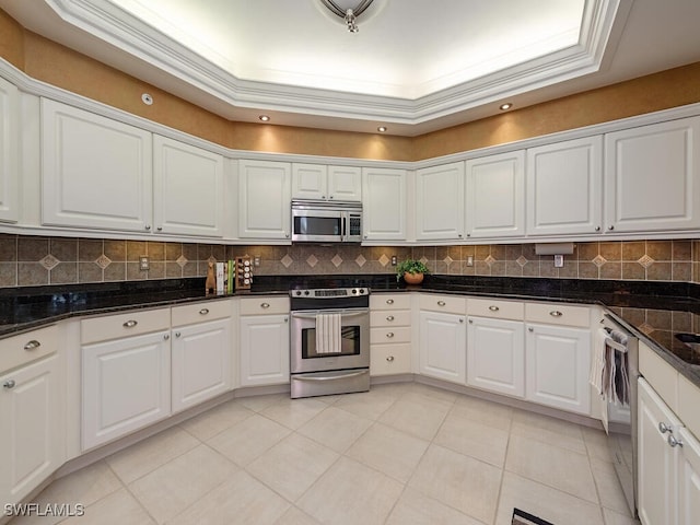 8440 Abbington Cir Unit D16, Naples, FL 34108 - kitchen with appliances with stainless steel finishes, white cabinetry, backsplash, and light tile patterned flooring