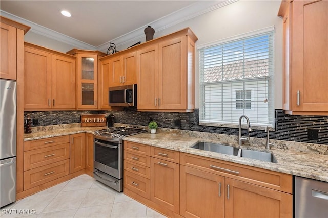 9022 Cascada Way Unit 201, Naples, FL 34114 - kitchen with stainless steel appliances, ornamental molding, a sink, light tile patterned floors, and backsplash
