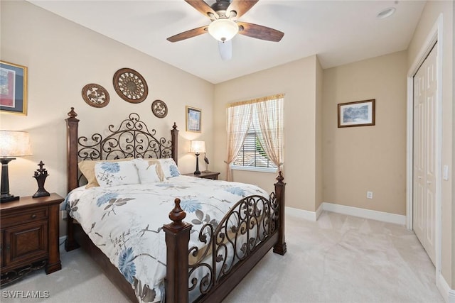 9022 Cascada Way Unit 201, Naples, FL 34114 - bedroom with light colored carpet, a closet, baseboards, and ceiling fan