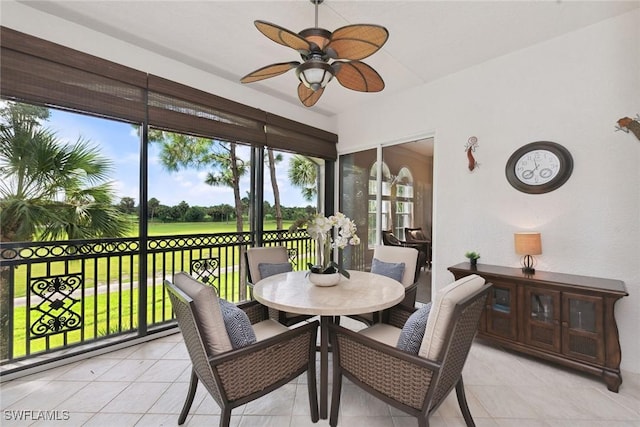 9022 Cascada Way Unit 201, Naples, FL 34114 - sunroom with ceiling fan, outdoor dining area, and golf course view