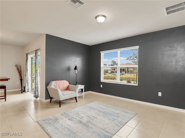 1036 Alaska Ave, Lehigh Acres, FL 33971 - sitting room featuring light tile patterned floors and baseboards