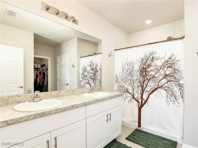 1036 Alaska Ave, Lehigh Acres, FL 33971 - full bathroom featuring double vanity, a walk in closet, curtained shower, and tile patterned flooring