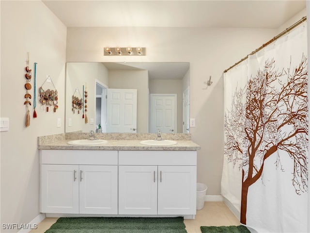 1036 Alaska Ave, Lehigh Acres, FL 33971 - bathroom featuring double vanity, tile patterned floors, baseboards, and a shower with shower curtain