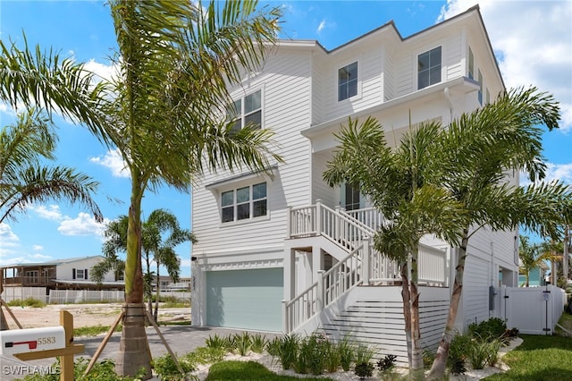 5583 Estero Blvd, Fort Myers Beach, FL 33931 - view of front facade with a garage, stairway, and driveway
