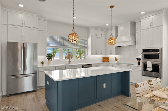 5583 Estero Blvd, Fort Myers Beach, FL 33931 - kitchen featuring appliances with stainless steel finishes, light countertops, white cabinets, premium range hood, and recessed lighting