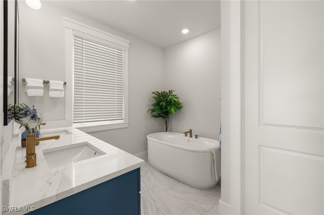 5583 Estero Blvd, Fort Myers Beach, FL 33931 - full bathroom with vanity, a freestanding tub, marble look tiles, and recessed lighting