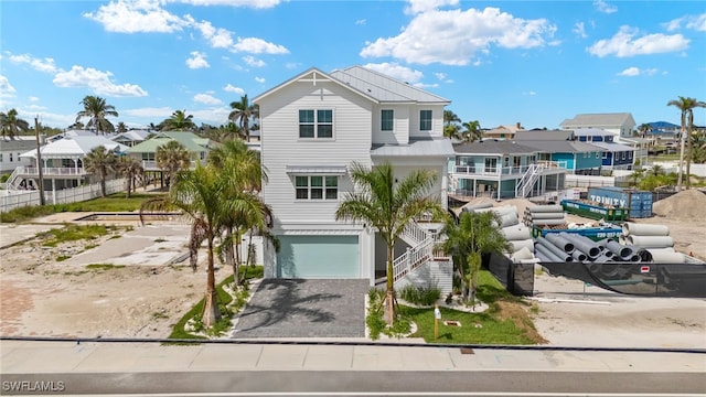 5583 Estero Blvd, Fort Myers Beach, FL 33931 - beach home with a residential view, driveway, a garage, and stairs