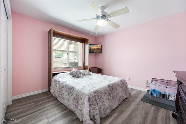 3628 NW 3rd Ter, Cape Coral, FL 33993 - bedroom with baseboards, wood finished floors, and a ceiling fan