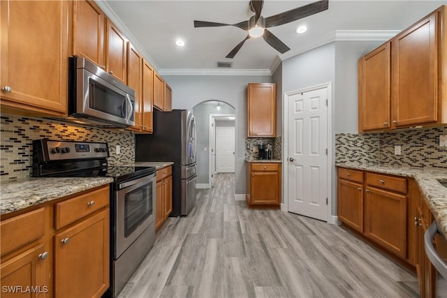3628 NW 3rd Ter, Cape Coral, FL 33993 - kitchen featuring appliances with stainless steel finishes, ornamental molding, a ceiling fan, backsplash, and recessed lighting