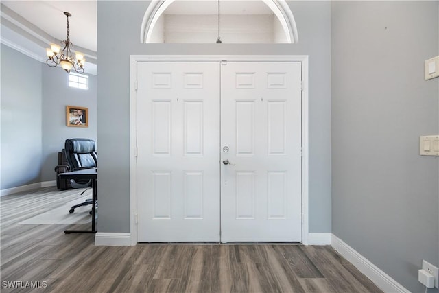 3628 NW 3rd Ter, Cape Coral, FL 33993 - foyer entrance featuring wood finished floors, baseboards, and a chandelier