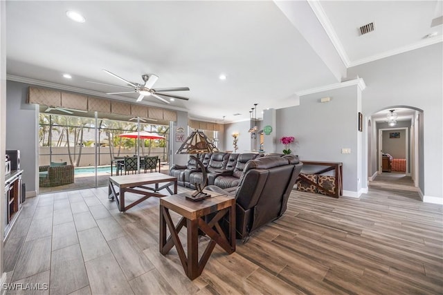 3628 NW 3rd Ter, Cape Coral, FL 33993 - living area featuring arched walkways, a ceiling fan, baseboards, recessed lighting, and crown molding