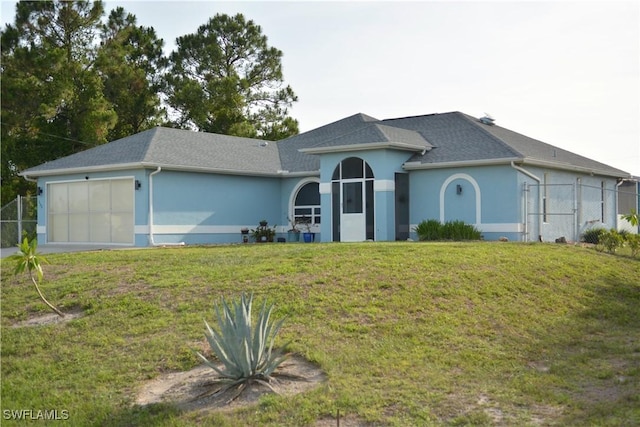 306 Pendleton Ave, Lehigh Acres, FL 33974 - ranch-style home with stucco siding, an attached garage, a shingled roof, and a gate