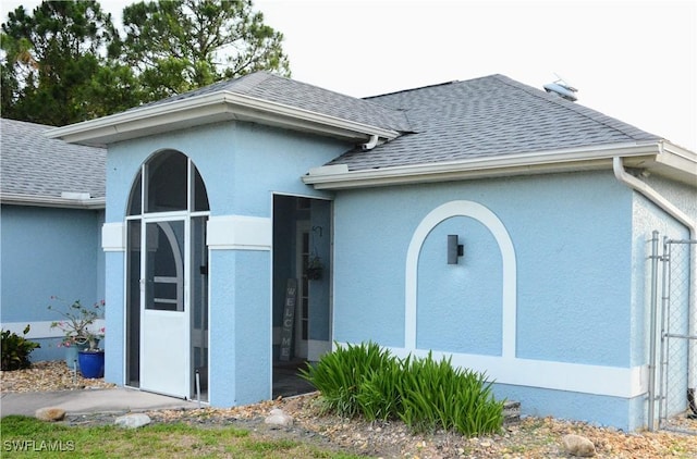 306 Pendleton Ave, Lehigh Acres, FL 33974 - view of front facade with roof with shingles and stucco siding