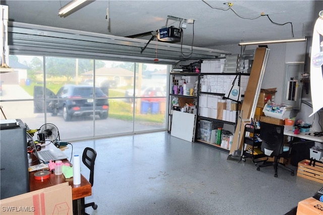 306 Pendleton Ave, Lehigh Acres, FL 33974 - garage with electric panel, an office area, and a garage door opener