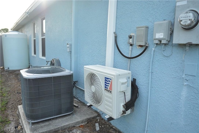 306 Pendleton Ave, Lehigh Acres, FL 33974 - exterior view of central AC, electric meter, ac unit, and stucco siding