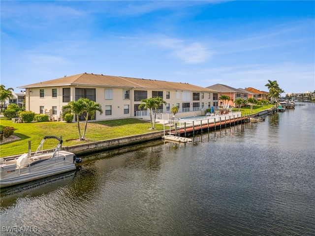 4538 SE 5th Pl Unit 3, Cape Coral, FL 33904 - dock area featuring a water view, a residential view, and a lawn