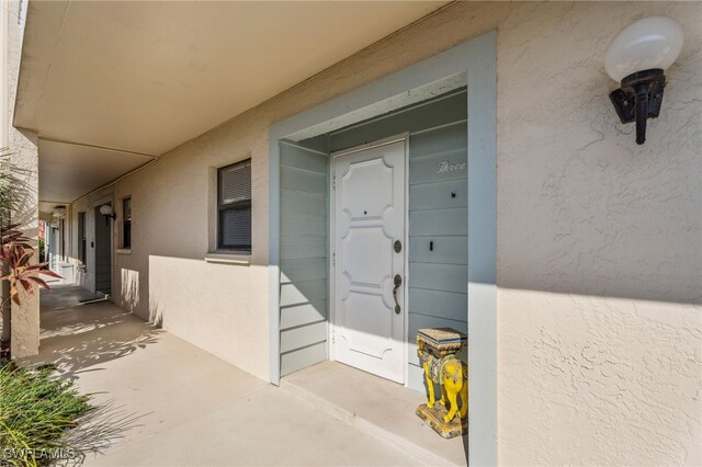 4538 SE 5th Pl Unit 3, Cape Coral, FL 33904 - doorway to property featuring stucco siding