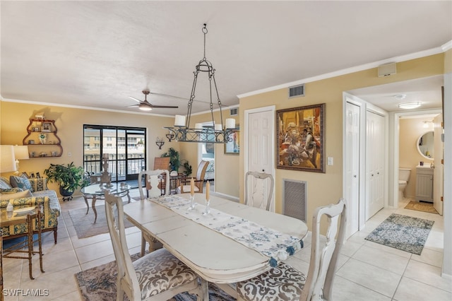 4538 SE 5th Pl Unit 3, Cape Coral, FL 33904 - dining room with light tile patterned flooring, crown molding, and a ceiling fan