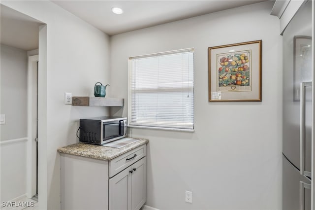4538 SE 5th Pl Unit 3, Cape Coral, FL 33904 - kitchen with stainless steel microwave and light stone counters