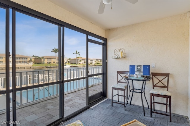 4538 SE 5th Pl Unit 3, Cape Coral, FL 33904 - sunroom / solarium featuring a textured wall, a water view, and a residential view