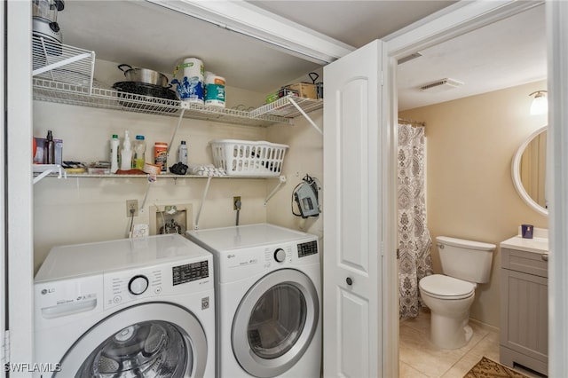 4538 SE 5th Pl Unit 3, Cape Coral, FL 33904 - washroom with washing machine and clothes dryer and light tile patterned floors
