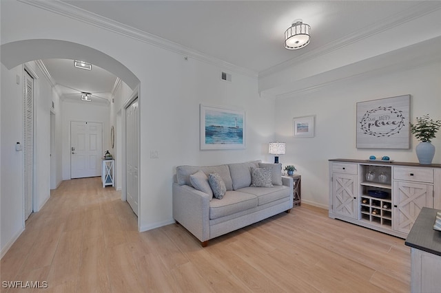10275 Heritage Bay Blvd Unit 737, Naples, FL 34120 - living area featuring arched walkways, crown molding, light wood-type flooring, and baseboards