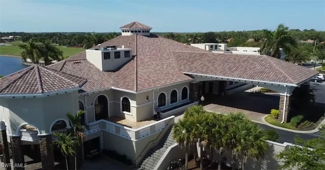 10275 Heritage Bay Blvd Unit 737, Naples, FL 34120 - rear view of property featuring stucco siding and a tile roof