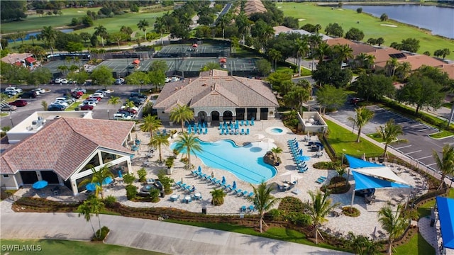 10275 Heritage Bay Blvd Unit 737, Naples, FL 34120 - drone / aerial view of a golf club, a pool, and a large body of water