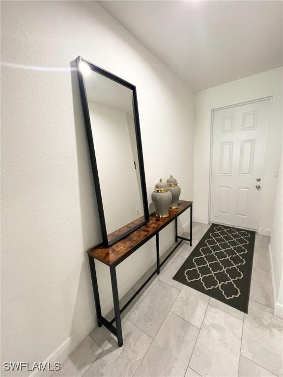 8040 Buttercup Cir, Labelle, FL 33935 - entryway featuring baseboards and light marble finish flooring