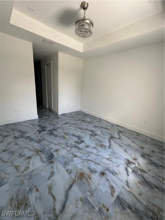 363 SW 24th Ct, Cape Coral, FL 33991 - unfurnished room featuring a tray ceiling, marble finish floors, and baseboards