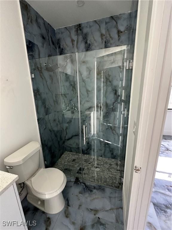 363 SW 24th Ct, Cape Coral, FL 33991 - bathroom with marble look tile flooring, vanity, a marble finish shower, and toilet