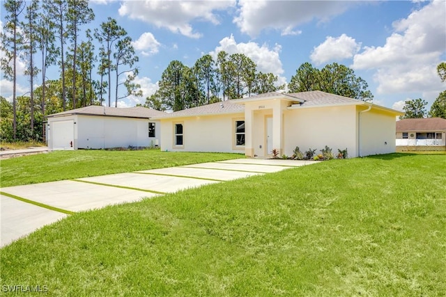 2511 45th St W, Lehigh Acres, FL 33971 - view of front facade featuring a front yard and stucco siding