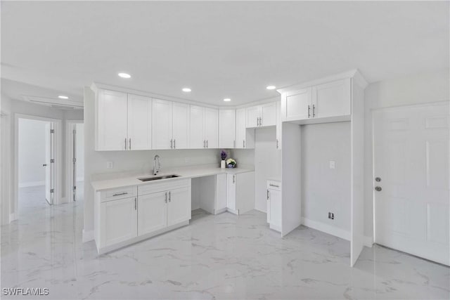 2511 45th St W, Lehigh Acres, FL 33971 - kitchen with a sink, light marble finish flooring, baseboards, recessed lighting, and white cabinetry