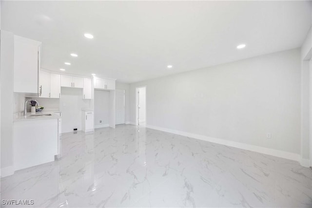 2511 45th St W, Lehigh Acres, FL 33971 - unfurnished living room featuring a sink, recessed lighting, baseboards, and light marble finish floors