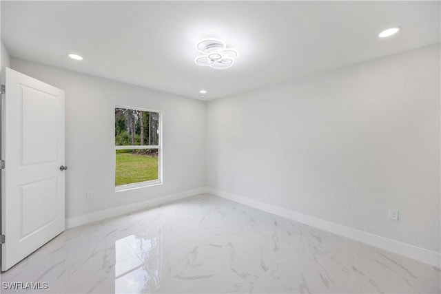 2511 45th St W, Lehigh Acres, FL 33971 - spare room featuring baseboards, light marble finish flooring, and recessed lighting