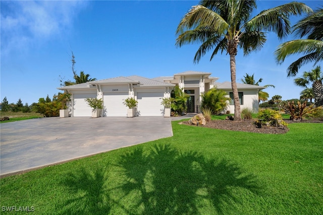 2405 SW 11th Ave, Cape Coral, FL 33991 - prairie-style house featuring concrete driveway, stucco siding, a front yard, and an attached garage