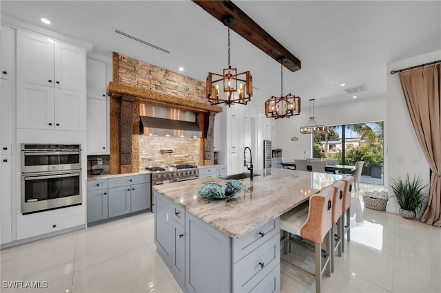 2405 SW 11th Ave, Cape Coral, FL 33991 - kitchen featuring a sink, a chandelier, appliances with stainless steel finishes, decorative backsplash, and light tile patterned floors