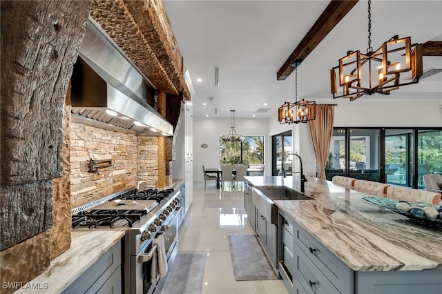 2405 SW 11th Ave, Cape Coral, FL 33991 - kitchen featuring double oven range, wall chimney range hood, a sink, gray cabinetry, and recessed lighting