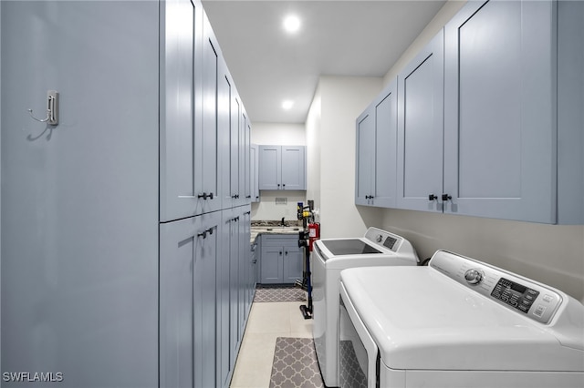 2405 SW 11th Ave, Cape Coral, FL 33991 - washroom featuring washing machine and clothes dryer, cabinet space, light tile patterned floors, and recessed lighting